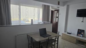 a room with a table with a laptop on it at Maritimo Apartment in Constanţa