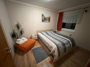 a small bedroom with a bed and a window at Beška in Bešeňová