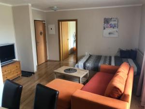 a living room with a couch and a bed at Beška in Bešeňová