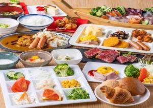 a table with many plates of different types of food at APA Hotel Namba Ekihigashi in Osaka +87 photos