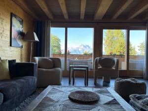 a living room with a couch and two chairs and a table at Chalet La Renarde in Villars-sur-Ollon