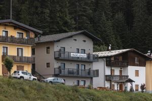 a large building with cars parked in front of it at Chalet Strui in Danta