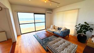 a living room with a view of the beach at Ocean view JUN in Shima +28 photos