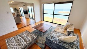 a living room with a couch and a table at Ocean view JUN in Shima