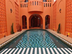 an indoor swimming pool in a building with a tile floor at Güzel Villa Bali in Badung +29 photos