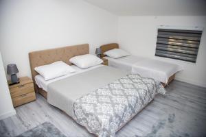 a bedroom with two beds and a window at Private Riverside Villa Silvia in Mostar