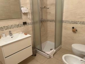 a bathroom with a shower and a sink and a toilet at Casa 2019 in Matera