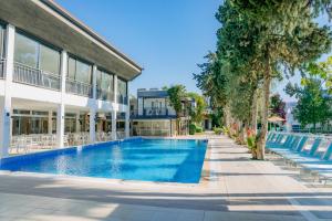 a swimming pool in front of a building at Bitez Garden Life in Bitez