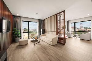 a living room with a couch and a table at MT Collection Hotel in Ninh Binh
