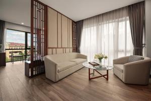 a living room with two chairs and a table at MT Collection Hotel in Ninh Binh