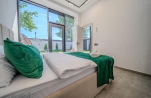 a bedroom with a bed with a large window at Qafqaz Four Seasons in Gabala +26 photos