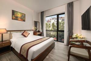 a hotel room with a bed and a window at MT Collection Hotel in Ninh Binh +85 photos