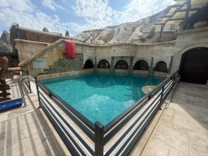 a swimming pool on a balcony of a building at Miras Hotel in Göreme