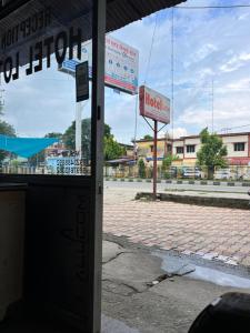a building with a hotel sign on a street at Hotel Lotus in Banbāsa +1 photo