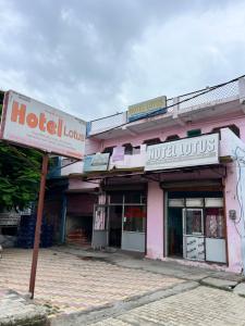 a hotel building with a sign in front of it at Hotel Lotus in Banbāsa