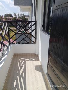 an open door to a balcony with a view at EMIC Suites in Nyahururu