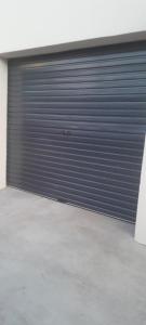 a garage door in a room with a concrete floor at Eagles Accommodation in Colesberg