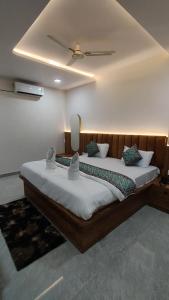 a bedroom with a large bed in a room at hotel shivam comfort in Dhārwād