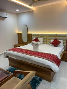 a bedroom with a large bed in a room at hotel shivam comfort in Dhārwād