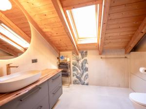 a bathroom with a white sink and a skylight at Apartment Bergraum - familienfreundlich und zentral in Sankt Englmar +13 photos