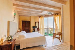 a bedroom with a large white bed and a window at Locanda Belvedere in Saludecio +41 photos