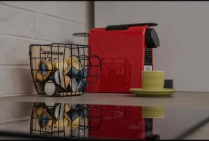 a counter with a basket of cups and a juicer at Dimitra Suites in Pythagoreio +4 photos