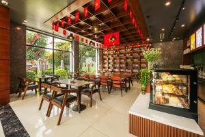 a restaurant with tables and chairs in a room at MT Collection Hotel in Ninh Binh