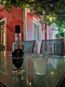a bottle of alcohol sitting on a table next to a glass at Plomari Rum Evi in Plomari