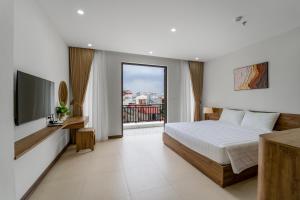 a bedroom with a bed and a flat screen tv at Gao House in Hanoi