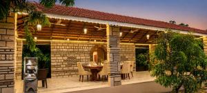 a patio with a table and chairs on it at Gir Vintage Villa in Sasan Gir