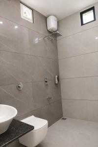 a bathroom with a toilet and a sink at Gir Vintage Villa in Sasan Gir +12 photos