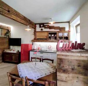 a kitchen with a table and a kitchen with a counter at Canton d'Antan in Saint Vincent +17 photos