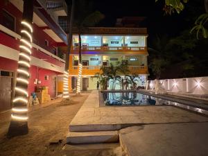 a building with lights in front of it at night at La Muthu Beach Stay in Pondicherry