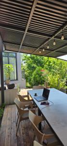 an outdoor patio with a table with a laptop on it at Ararat Terrace House in Ashtarak