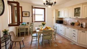 a kitchen with a table with fruits on it at Central Dorgali Guest House in Dorgali
