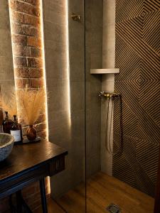 a shower with a glass door in a bathroom at Egri Leányka Vendégház in Eger