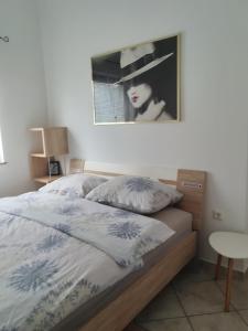 a bedroom with a bed with a picture on the wall at WoW sleeping in Miklavž na Dravskem Polju +51 photos