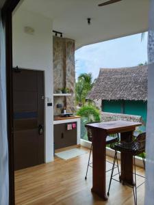 a kitchen with a table and a view of the ocean at Capricho Villa El Nido in El Nido