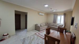 a living room with a table and a couch at حياة النعيم in Salalah