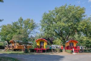 a group of play tents in a park at Camping Onlycamp du Rouergue in Villefranche-de-Rouergue