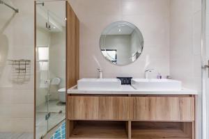 a bathroom with a sink and a mirror at Braham Lodge - The Octave 5 in Johannesburg +18 photos
