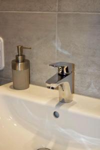 a bathroom sink with a faucet on top of it at Landhotel Laarmann in Lennestadt +42 photos