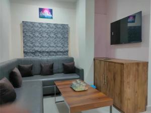 a living room with a couch and a coffee table at Hotel Abhijeet Inn in Raipur