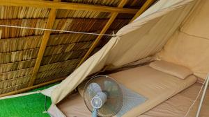 a room with a fan in a tent at Long Beach Camp in Perhentian Islands