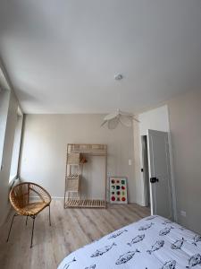 a white bedroom with a bed and a chair at Le Petit Bleu - Charming House in Yport