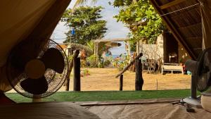 a view from inside a tent of a playground at Long Beach Camp in Perhentian Islands