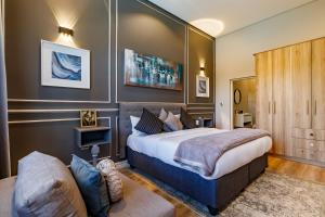 a bedroom with a large bed and a couch at Braham Lodge - The Octave 5 in Johannesburg