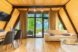 a living room with a couch and a table at Hatsvali Gate in Mestia +19 photos