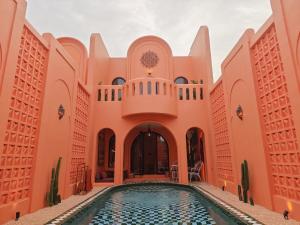 an exterior view of a building with a swimming pool at Güzel Villa Bali in Badung