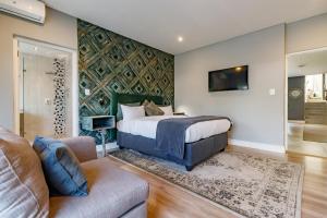 a bedroom with a bed and a couch at Braham Lodge - The Octave 5 in Johannesburg
